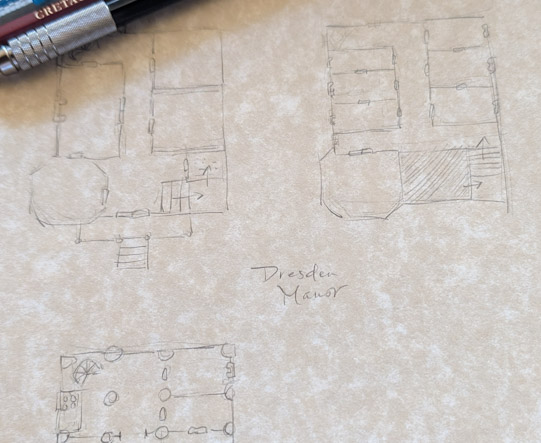 A hand-drawn map of Dresden Manor, with pencils overlaying the paper in the corner.