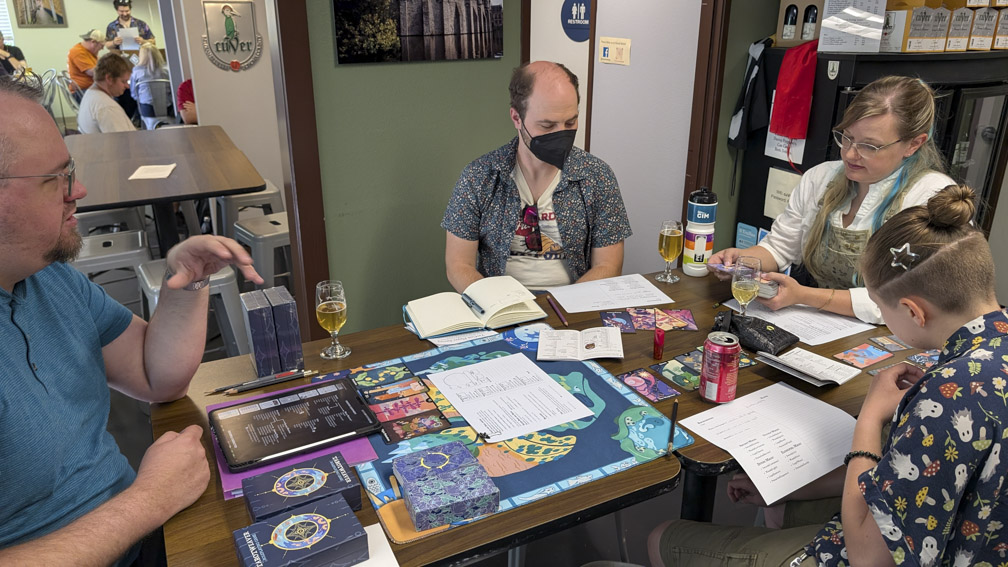 People playing Tarotweaver, a table-top role-playing game.